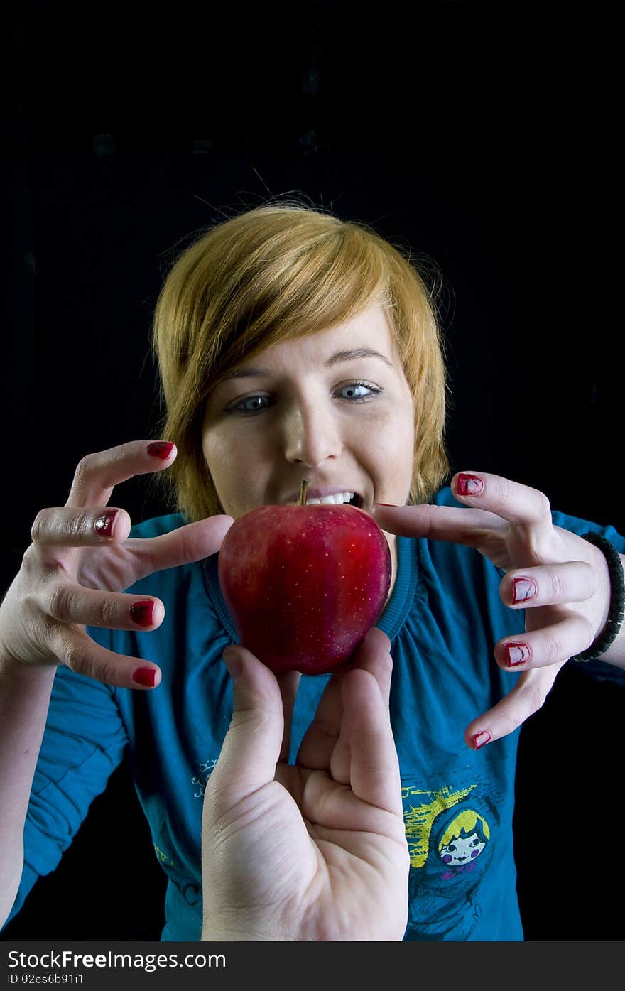 Cute young blond girl and her red apple. Cute young blond girl and her red apple