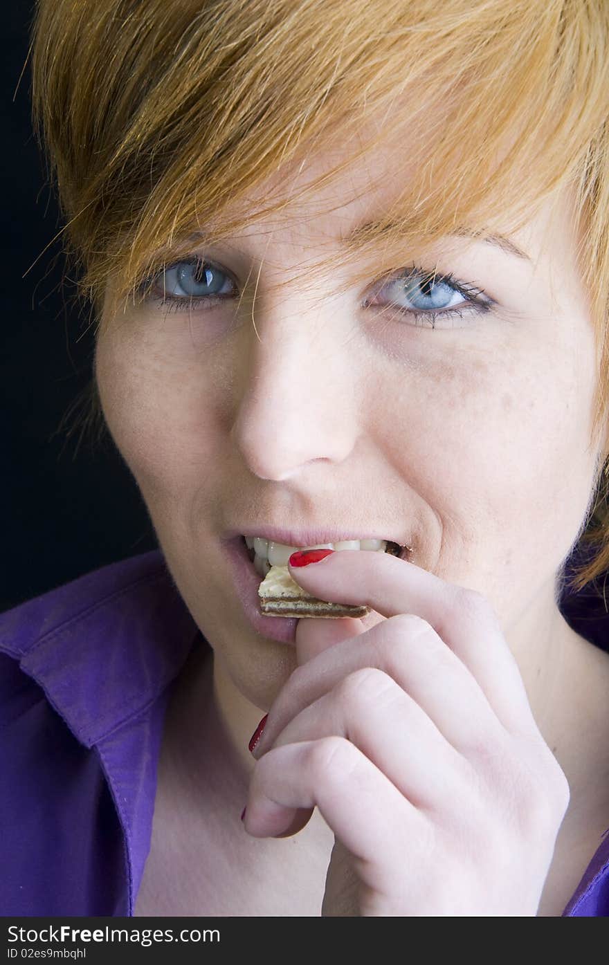 Cute girl eating a cookie