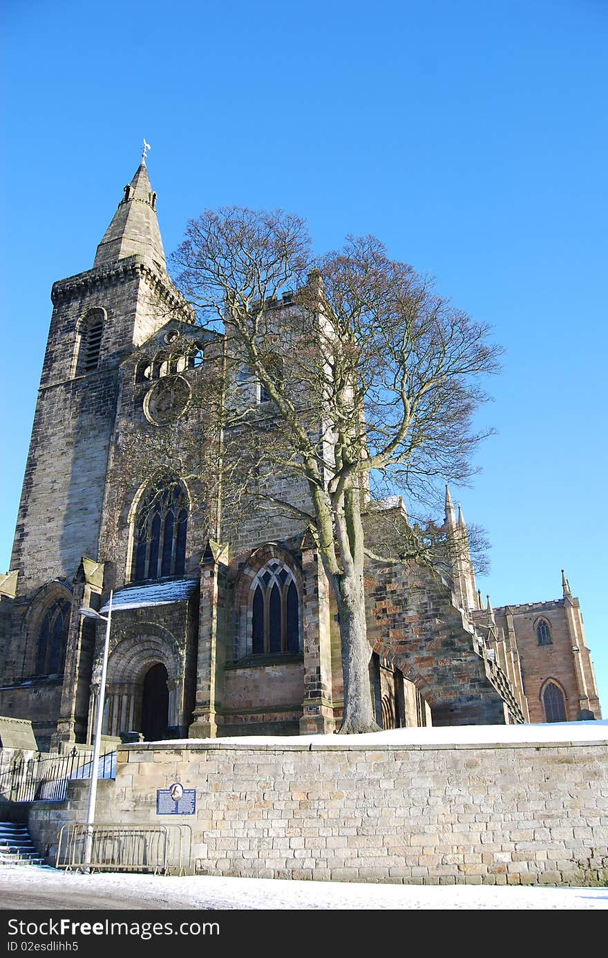 Dunfermline Abbey towers above the snow covered ground during a Scottish Winter. Dunfermline Abbey towers above the snow covered ground during a Scottish Winter