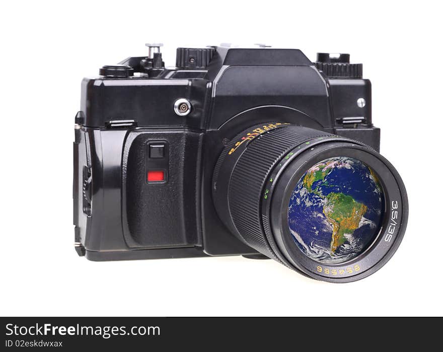 Old SLR camera. In a lens the globe is reflected. Isolated on a white background. Source from globe: http://visibleearth.nasa.gov/