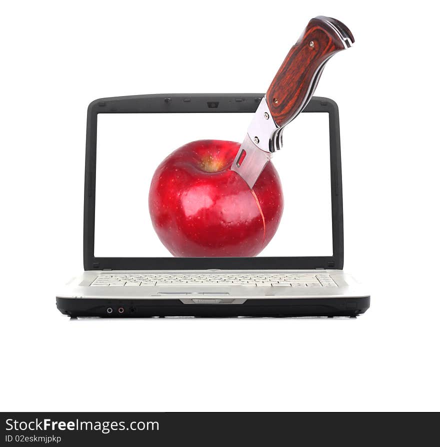 Knife cutting an apple on the screen laptop. Isolated on a white background