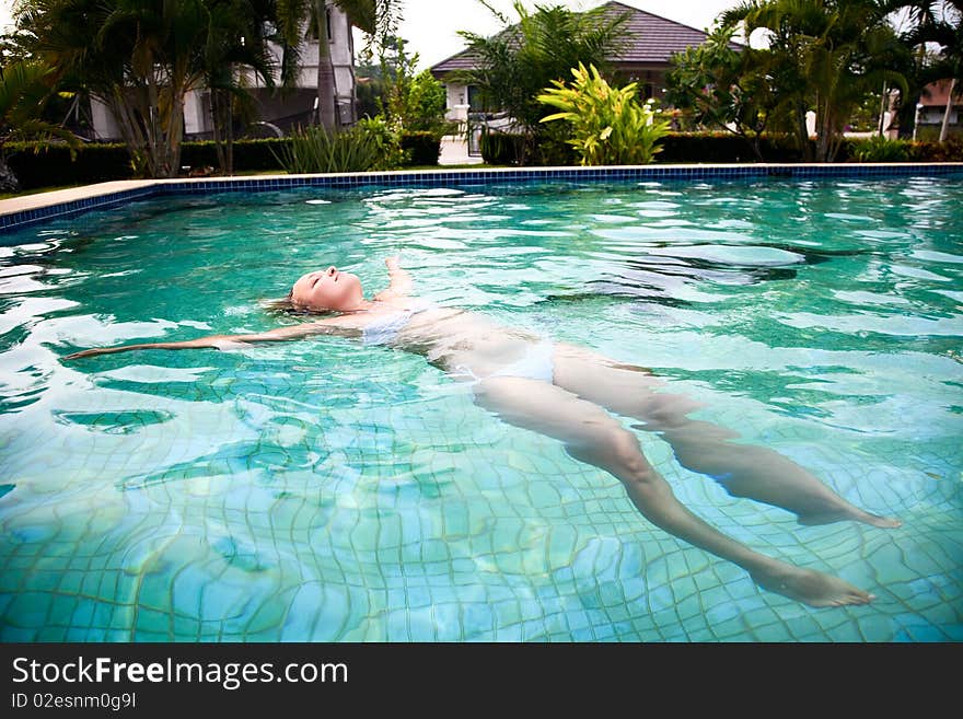 Beautiful woman relaxing in the pool