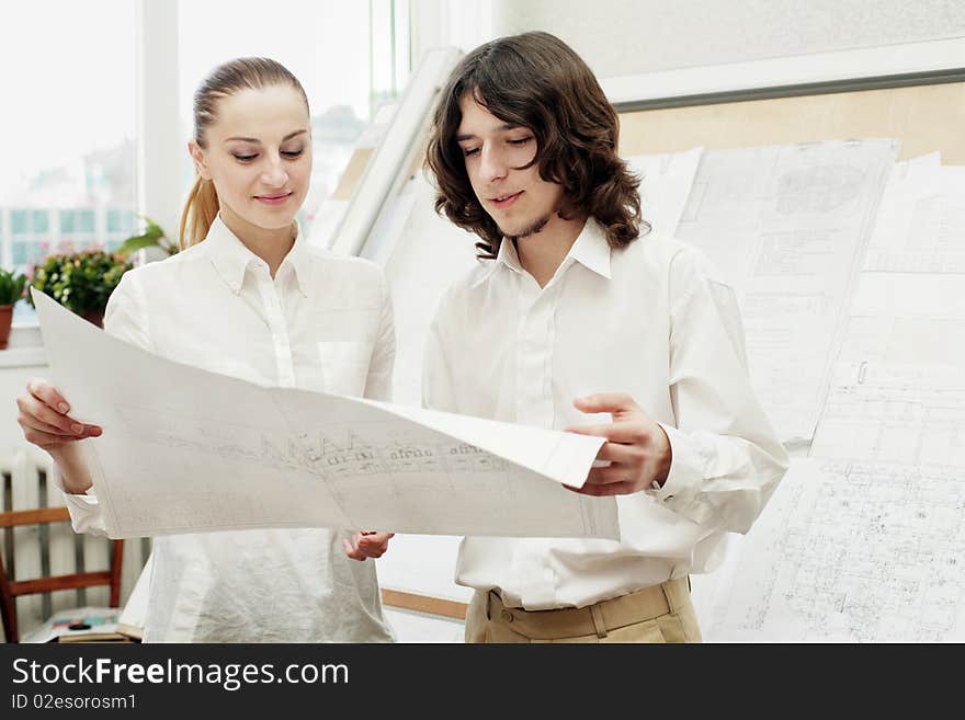 An image of architects busy with their work. An image of architects busy with their work