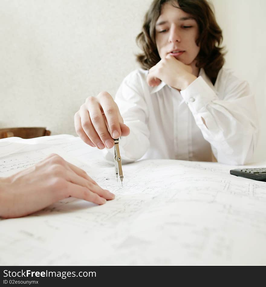 An image of a young architect, focus on a hand