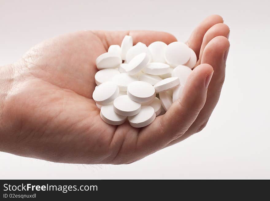 Many tablets in a man's palm closeup