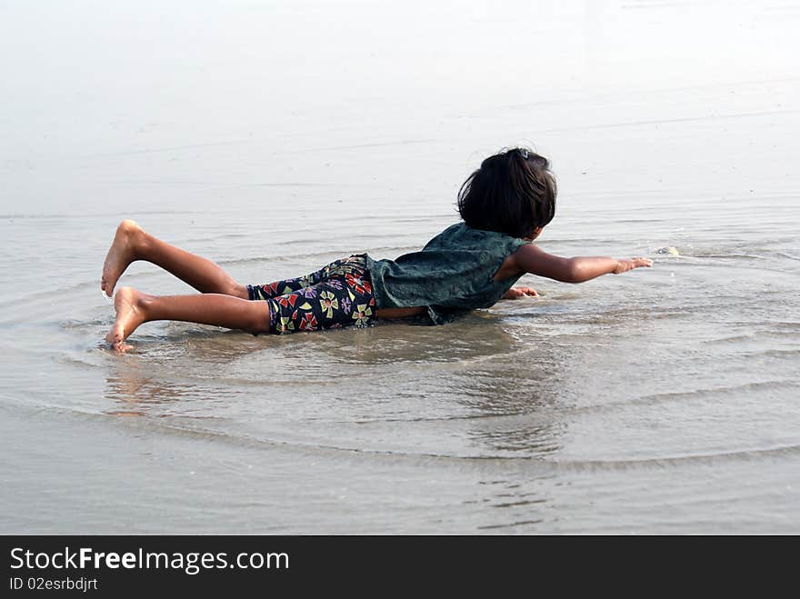 Happy indian girl play games on seacosts. Happy indian girl play games on seacosts