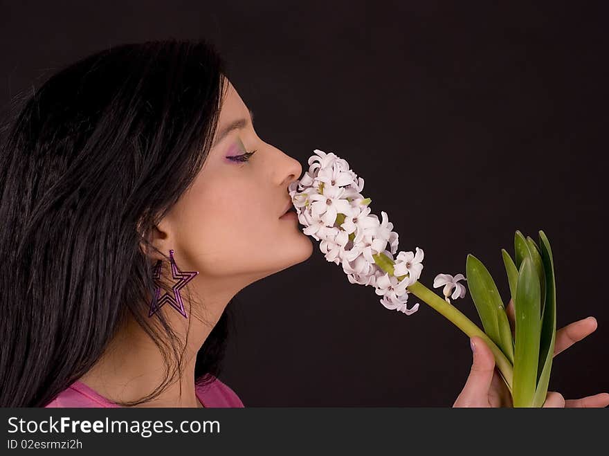 Girl smelling flower. Studio shot. Girl smelling flower. Studio shot.