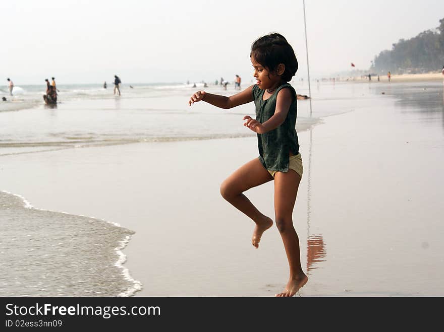 Happy indian girl play games on seacosts. Happy indian girl play games on seacosts