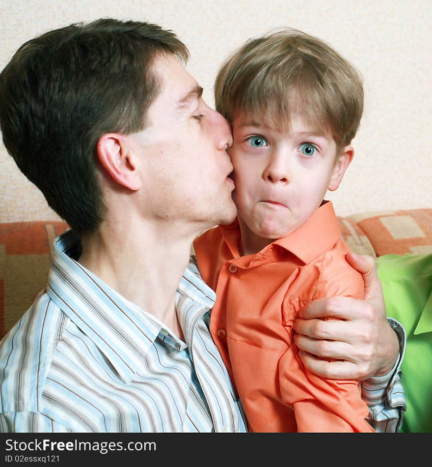 An image of a father kissing his son. An image of a father kissing his son