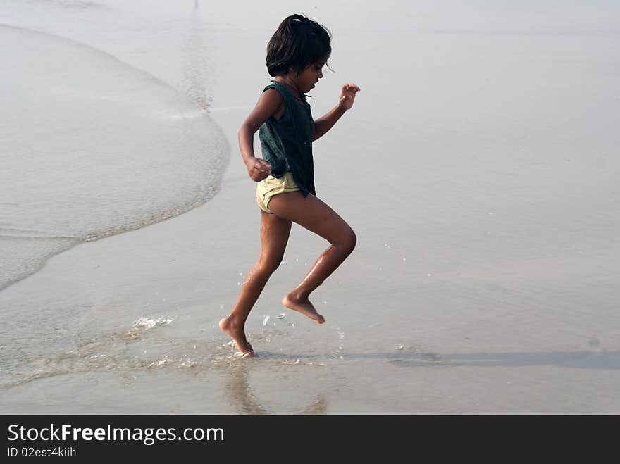 Happy indian girl play games on seacosts. Happy indian girl play games on seacosts