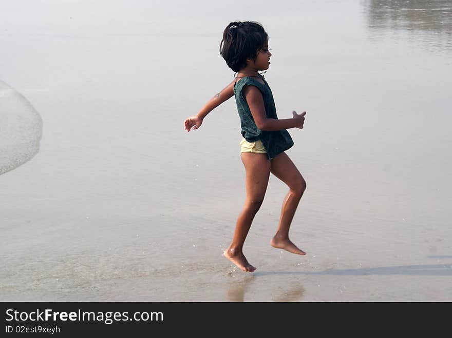 Happy indian girl play games on seacosts. Happy indian girl play games on seacosts