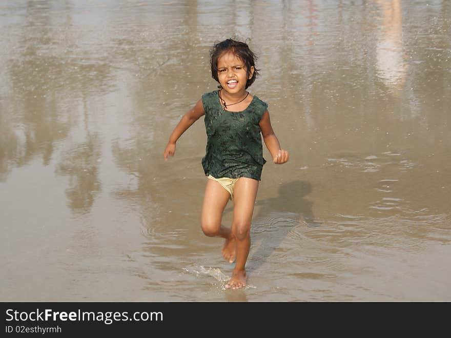 Happy indian girl play games on seacosts. Happy indian girl play games on seacosts