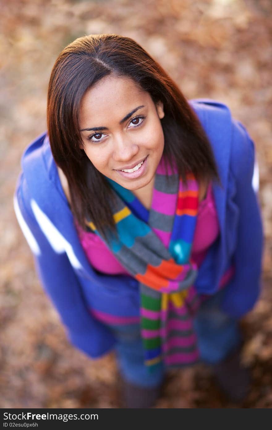 A young beautiful girl outside looking up at the camera. A young beautiful girl outside looking up at the camera