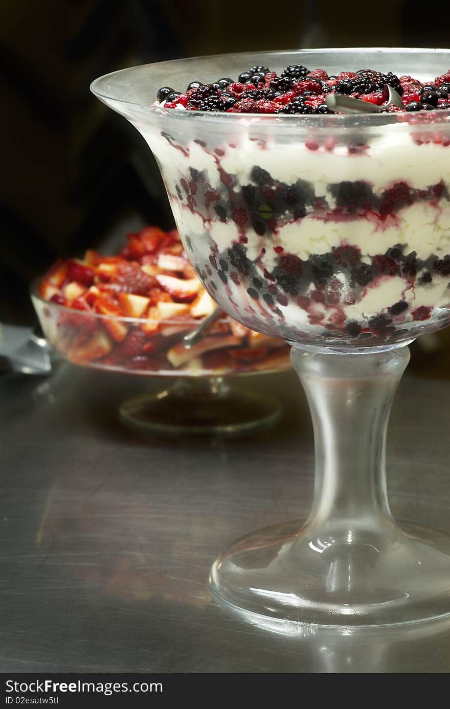 Fresh red blackberries and raspberries in a bowl with cream. Fresh red blackberries and raspberries in a bowl with cream