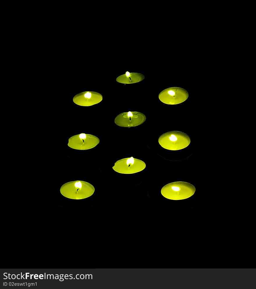 Green candle on a black background