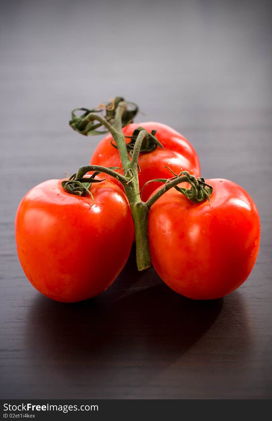 Fresh tomato branch on the table. Fresh tomato branch on the table