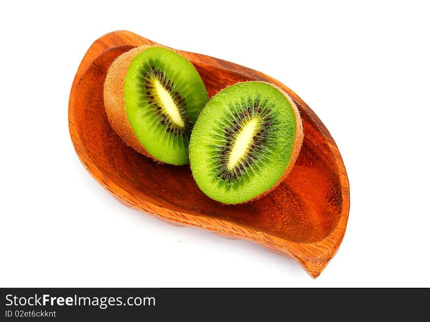 Kiwi fruit on a wooden plate. Isolation  on a white background