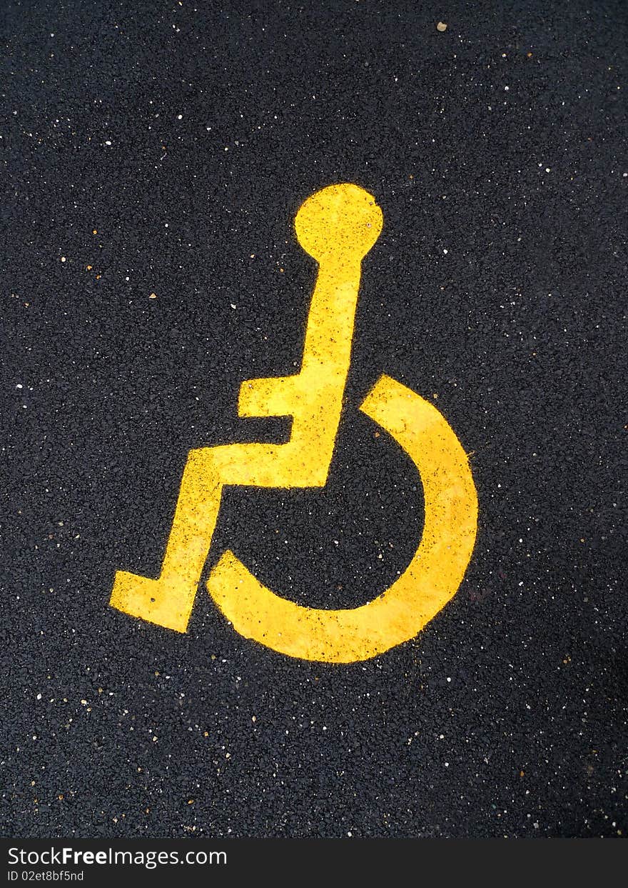 Â Asphalt road with yellow disable man logo