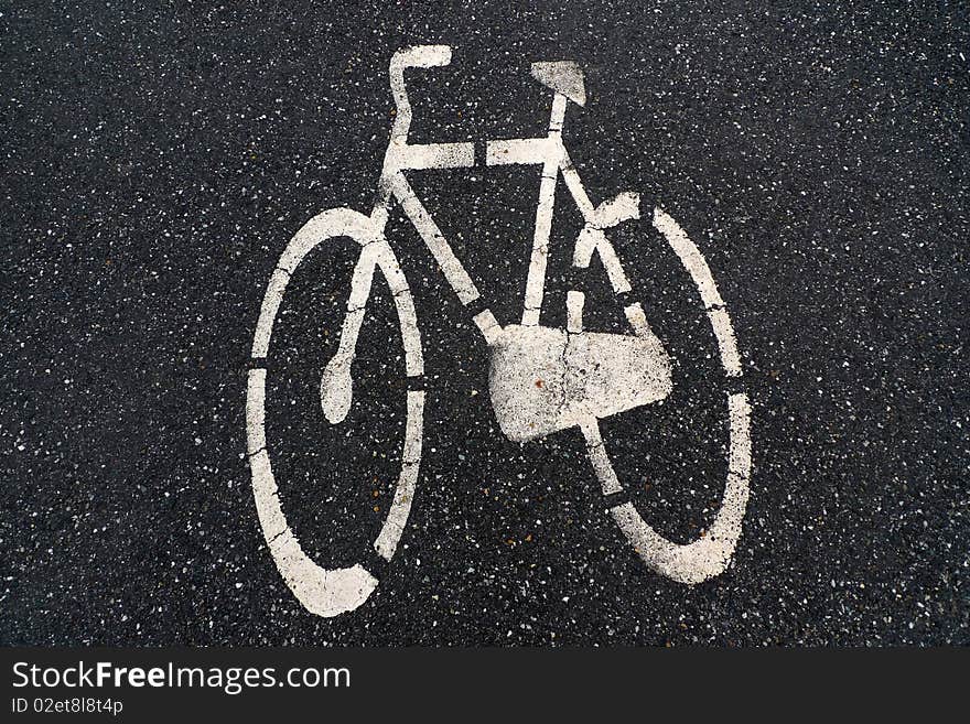  Asphalt road with white bike logo.  Asphalt road with white bike logo