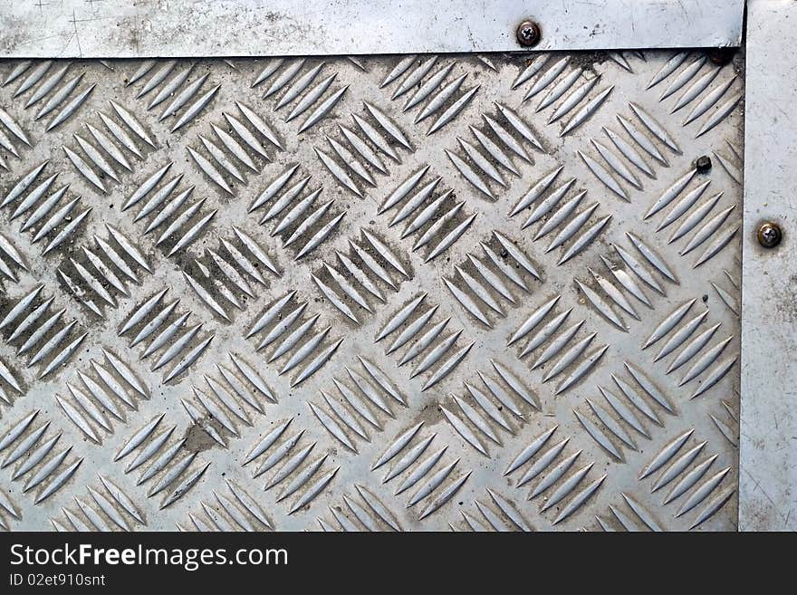 Detail of a grid whith board of steel placed along a road