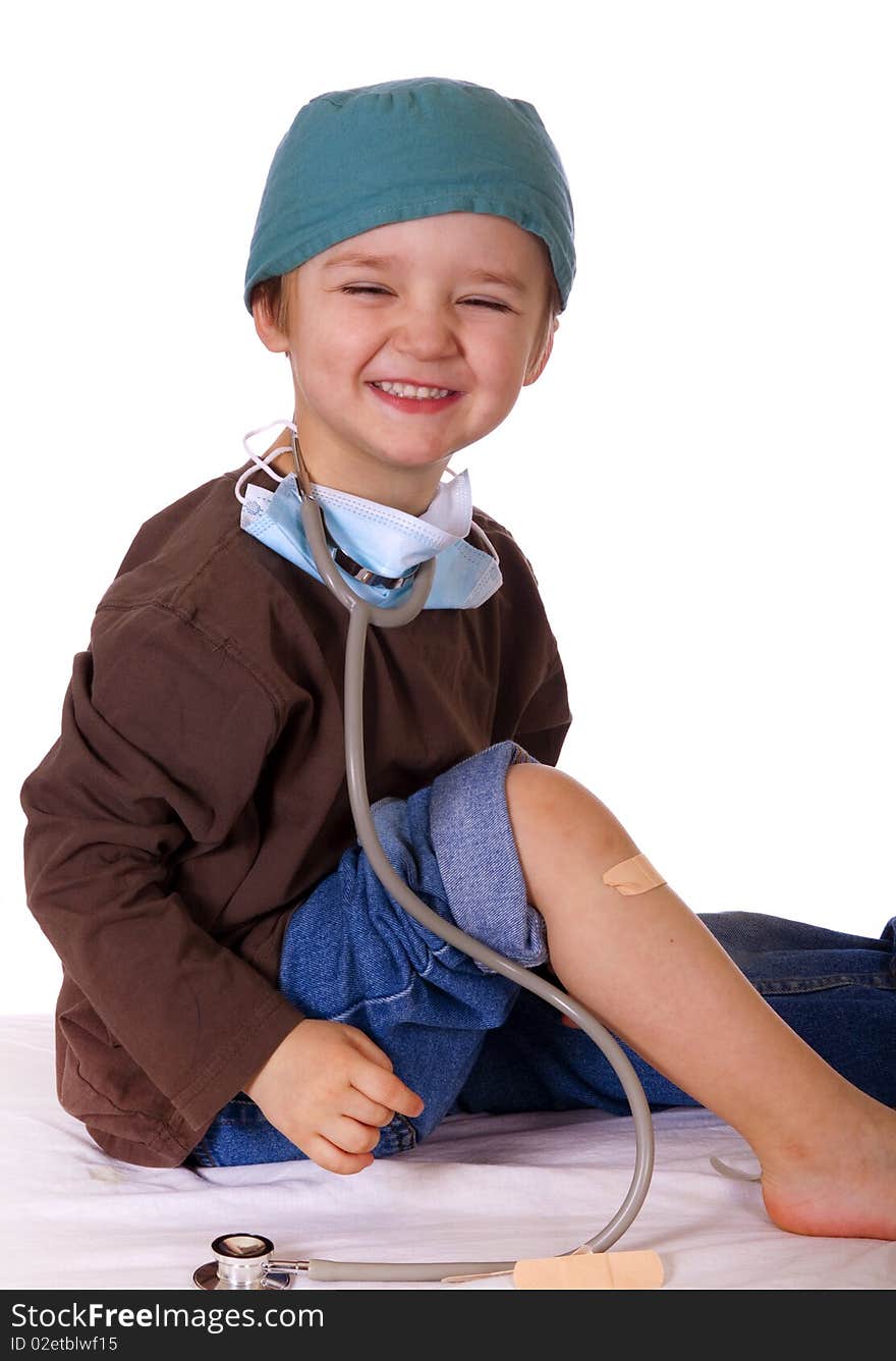 Smiling Caucasian boy playing doctor. Smiling Caucasian boy playing doctor