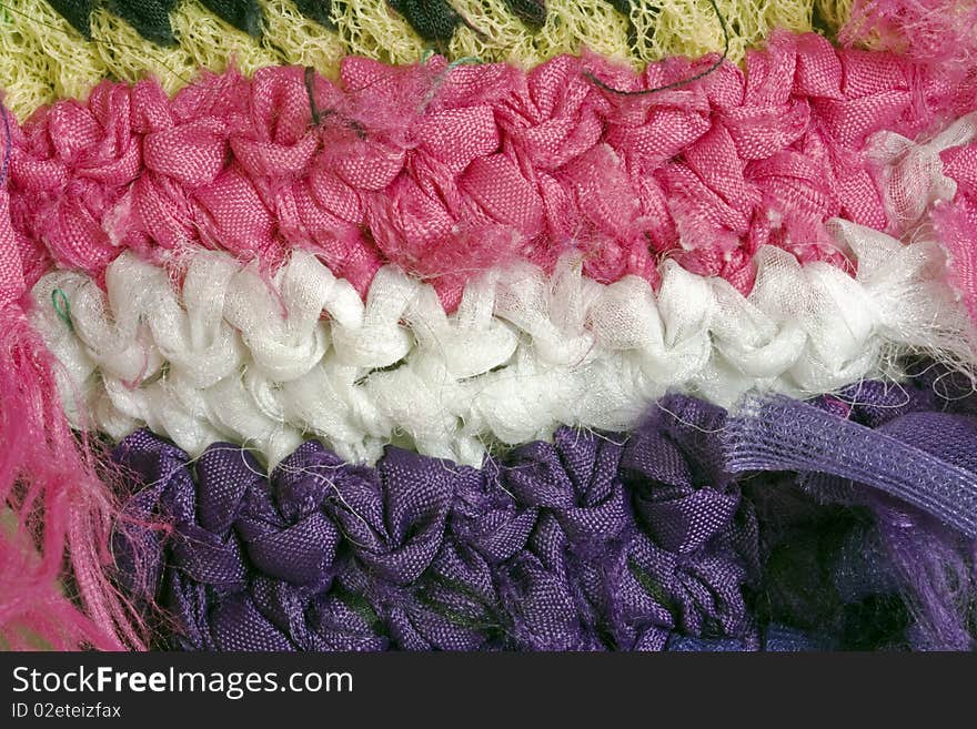 A close-up of a mixed material crochet wall hanging. A close-up of a mixed material crochet wall hanging