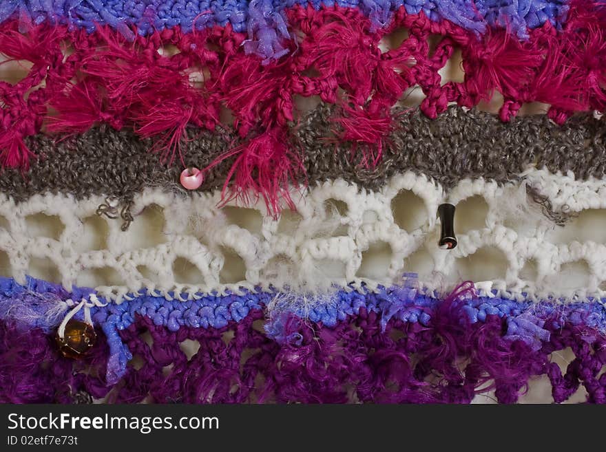 A close-up of a mixed material crochet wall hanging. A close-up of a mixed material crochet wall hanging