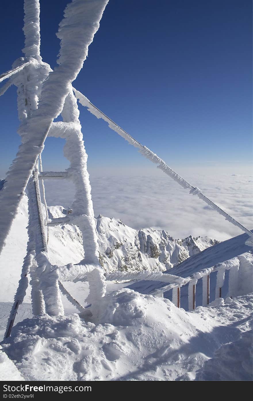 Ladder for cleaning very heavy white frost at high altitude, after strong wind and dense fog. Ladder for cleaning very heavy white frost at high altitude, after strong wind and dense fog