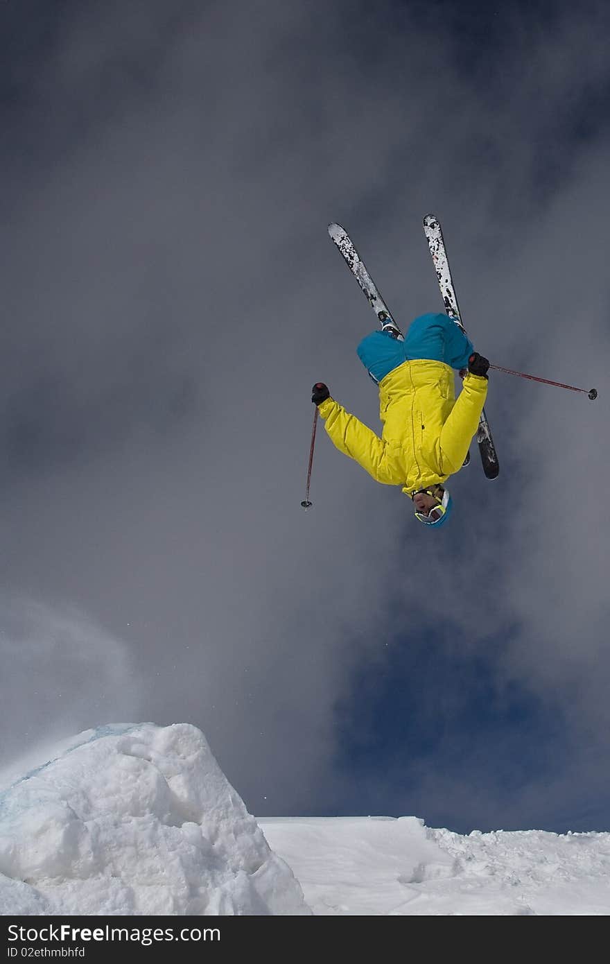 Skier doing a backflip off a backcountry jump. Skier doing a backflip off a backcountry jump.