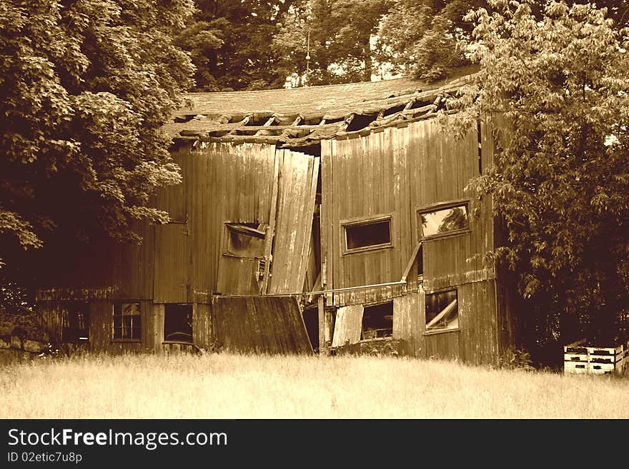 A old barn falling apart in Ohio in sepia. A old barn falling apart in Ohio in sepia