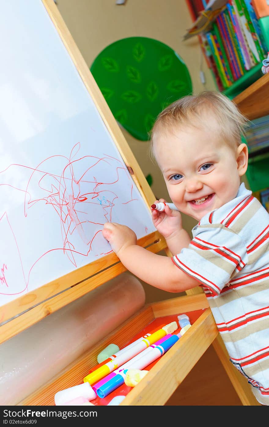 Cute one and half year old boy draws markers. Cute one and half year old boy draws markers