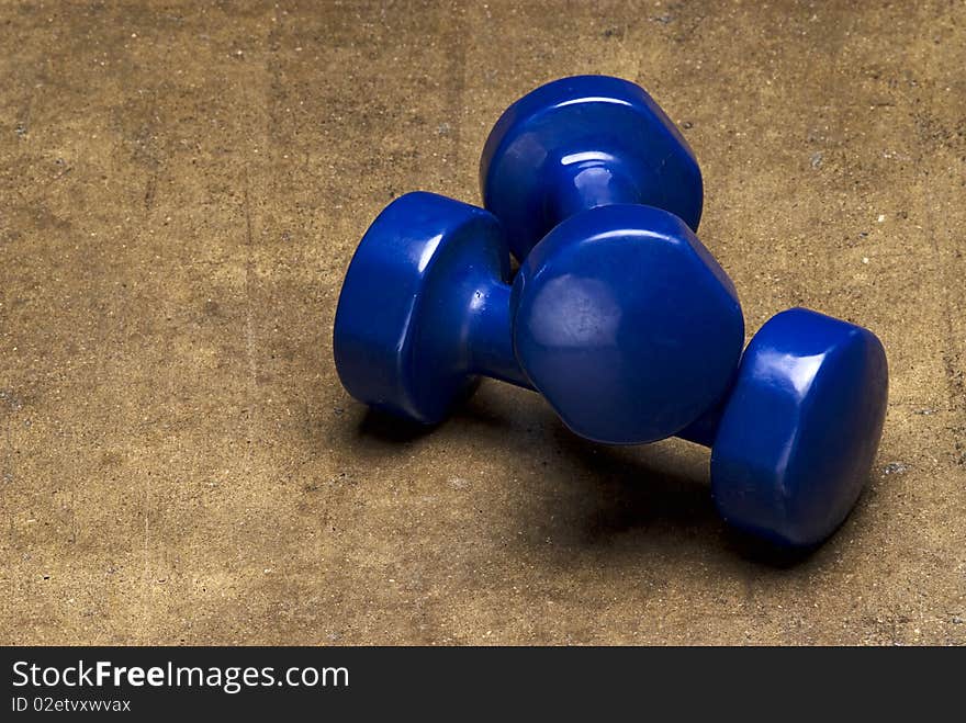 Blue dumbbells on grunge textured background