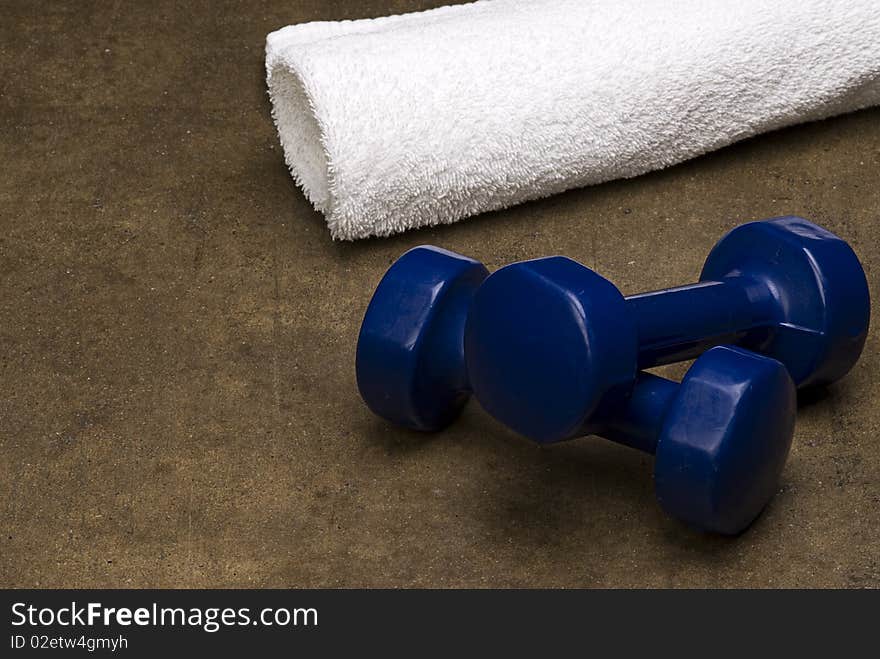 White Towel and Blue dumbbells