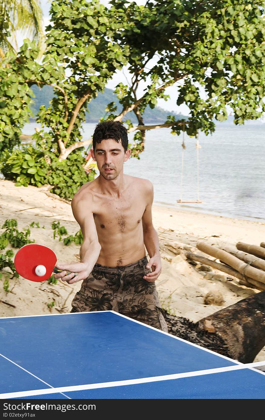 Man playing table tennis on beach. Man playing table tennis on beach