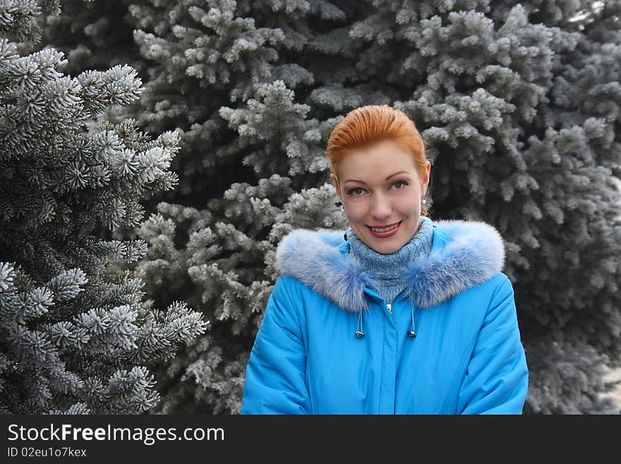 The red-haired girl against the frozen fur-trees. The red-haired girl against the frozen fur-trees