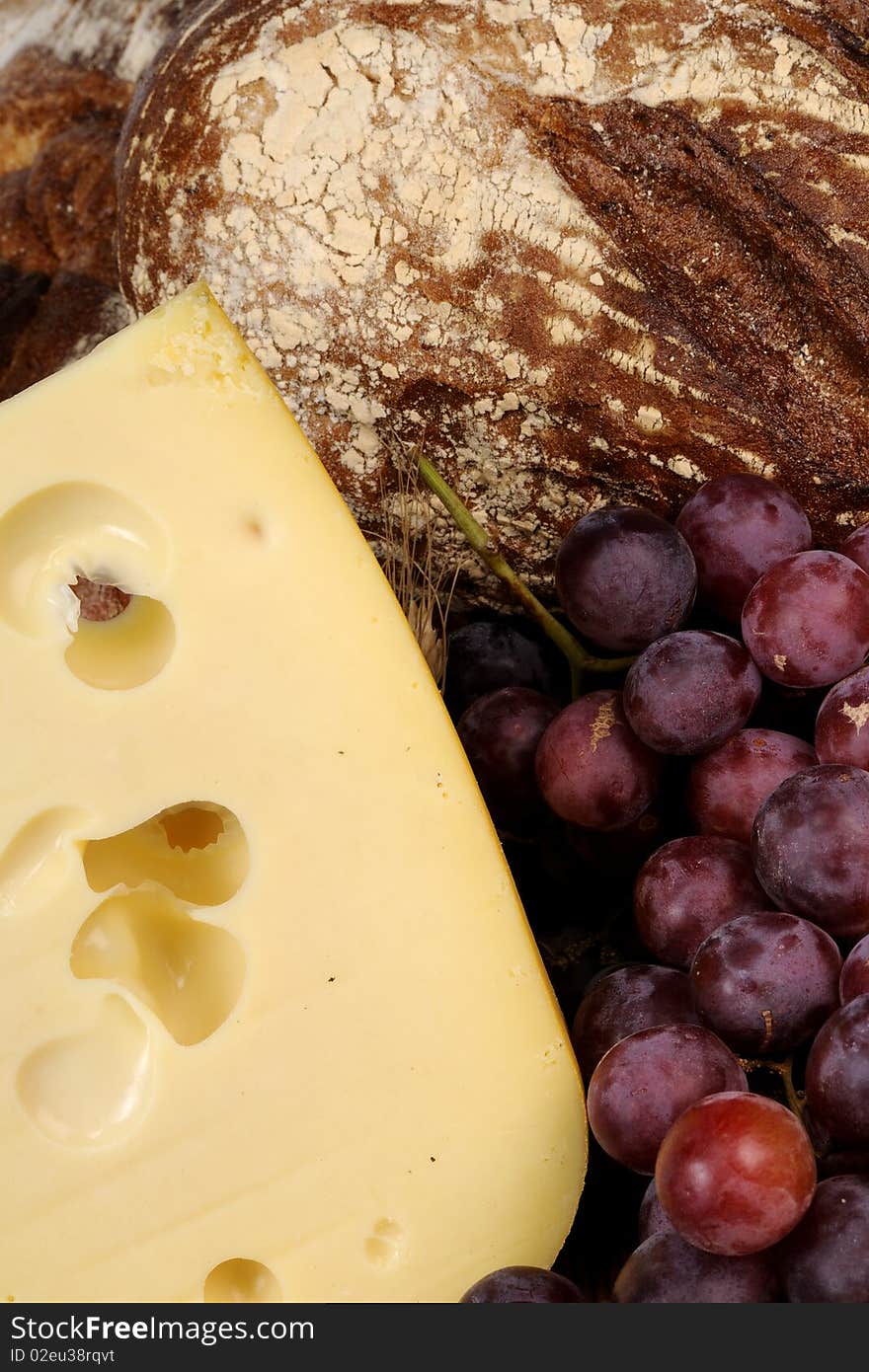 Cheese, Red Grapes And Bread Isolated