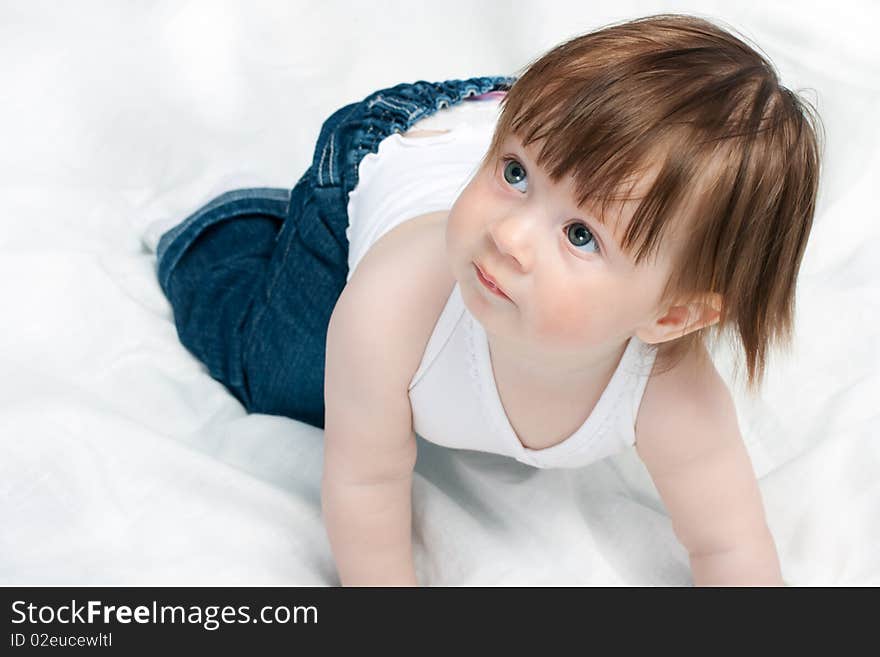 Little baby girl playing on the bed. Little baby girl playing on the bed