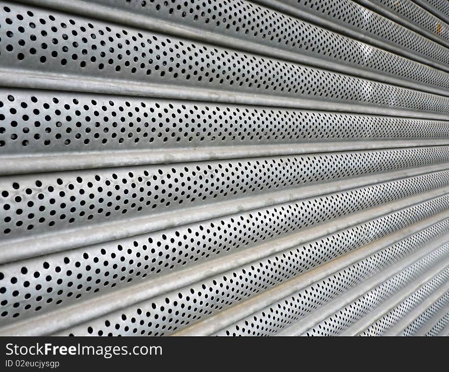 A closeup of a metal window shutter. A closeup of a metal window shutter