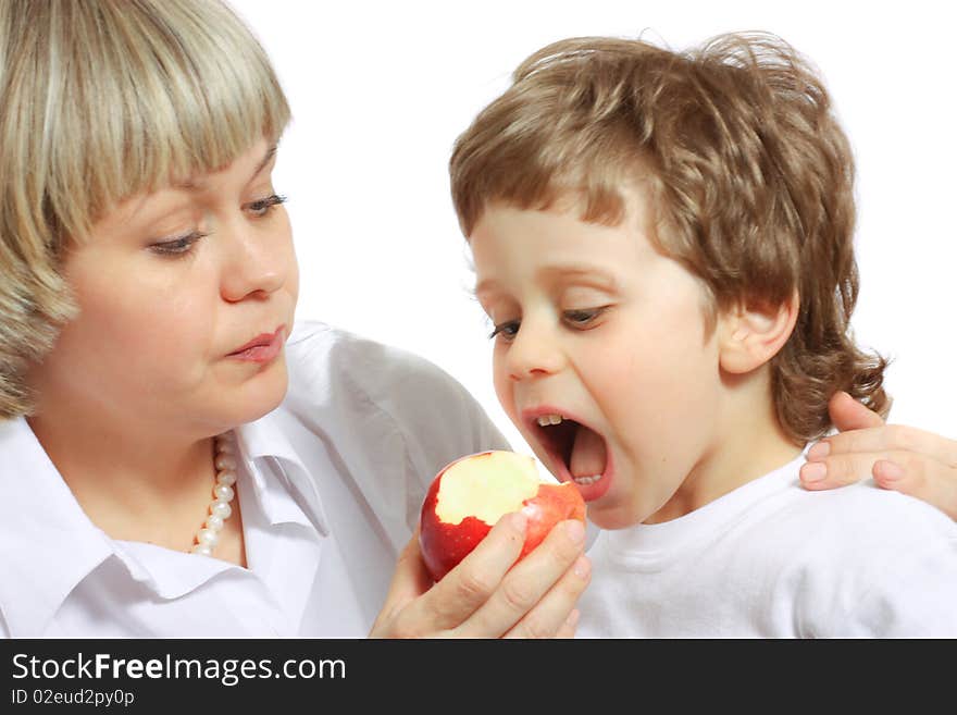 Woman and boy eating apple