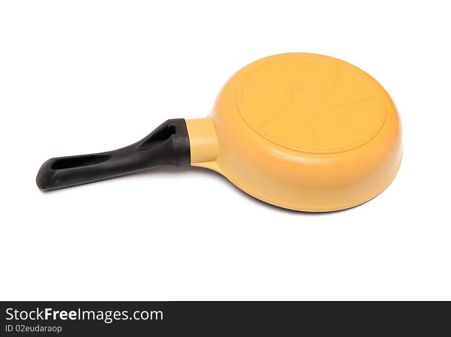 Black and yellow frying pan upside down isolated