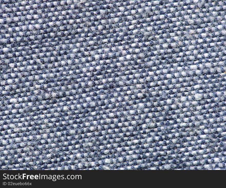 Closeup detail of the texture in a piece of blue fabric or cloth. Closeup detail of the texture in a piece of blue fabric or cloth.