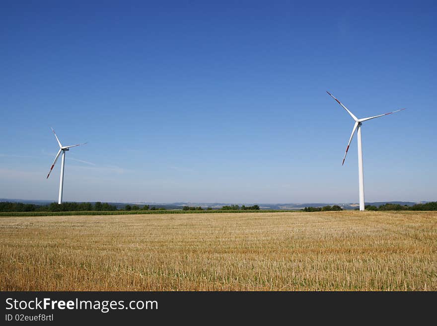 Wind turbines against blue sky