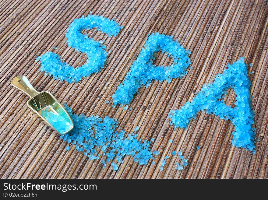 Spa concept. Sea salt on natural bamboo background.