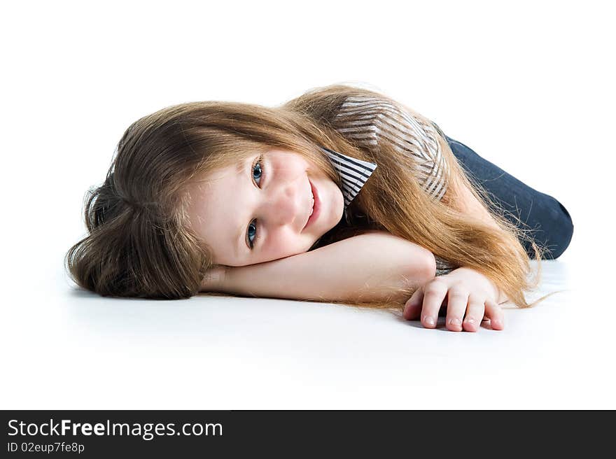 Beautiful little girl lie. Isolated on a white background