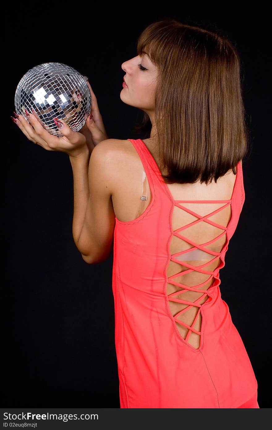 Girl with discoball on a black background