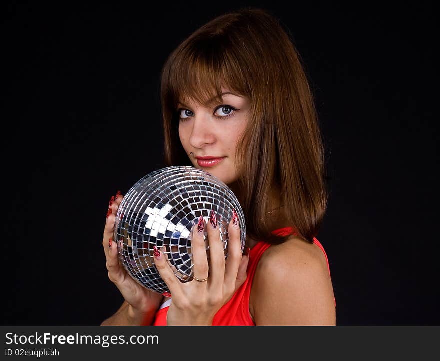 Girl with discoball on a black background