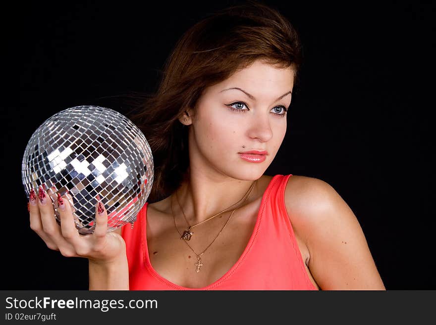 Girl with discoball on a black background