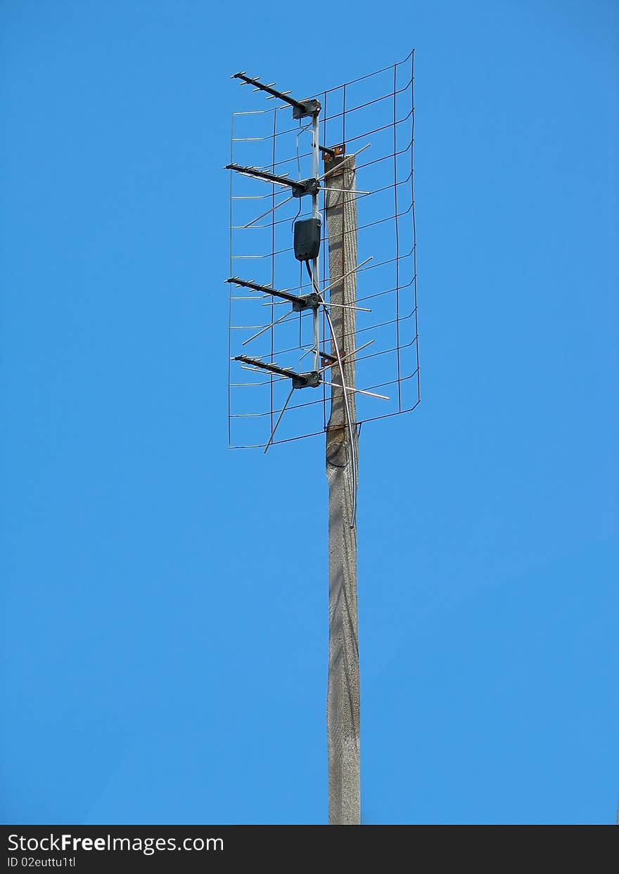 Old TV antenna over blue sky