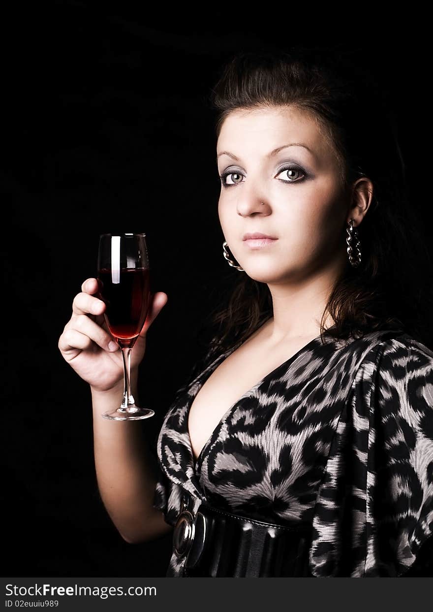 Elegant woman holding wine over dark