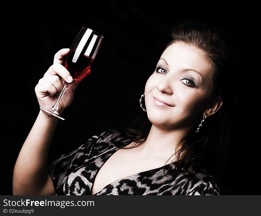 Elegant woman holding wine over dark